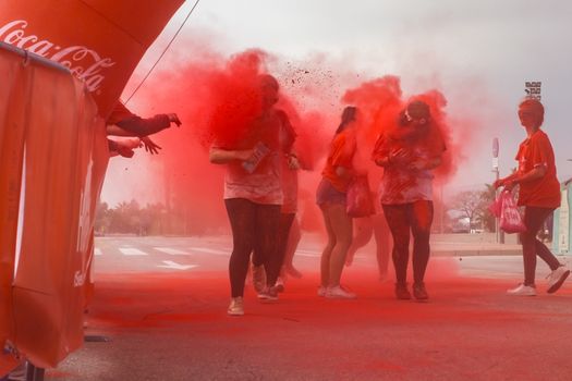 Malaga, Spain - February 18, 2018. Young people celebrate Holi color festival in Malaga, Spain.