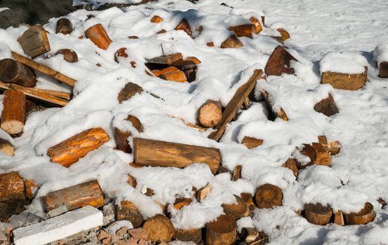 a pile of broken wood covered in snow