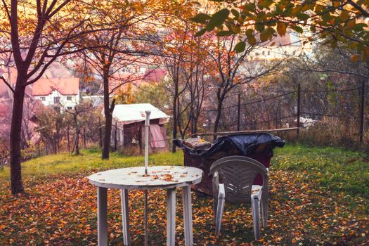 a plastic table and chairs in the garden