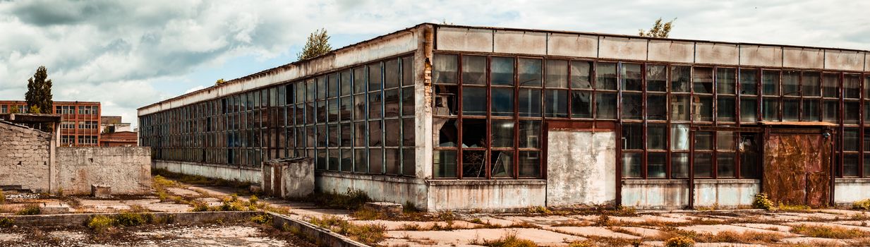 abandoned factory warehouse with broken windows