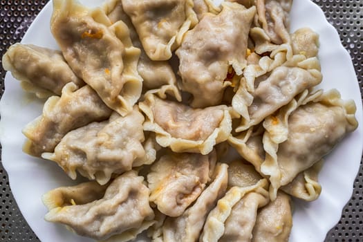 a white plate with chinese dumpling