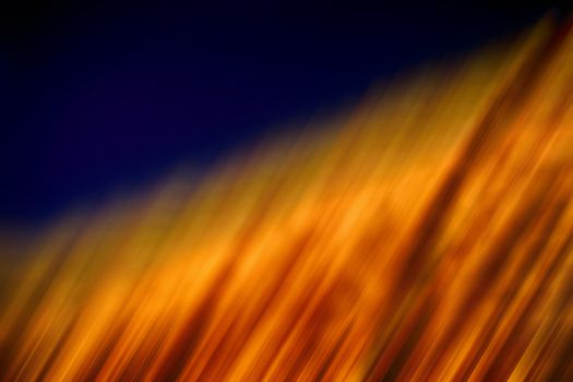 Abstract golden blurred light on dark background