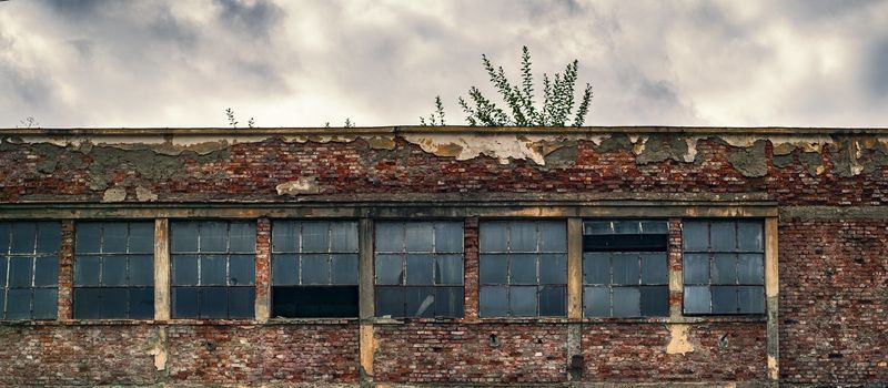 abandoned factory warehouse with broken windows