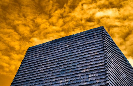 blue roof tile on orange cloudy sky