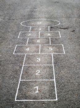 Children's Hopscotch Game on Asphalt City Sidewalk