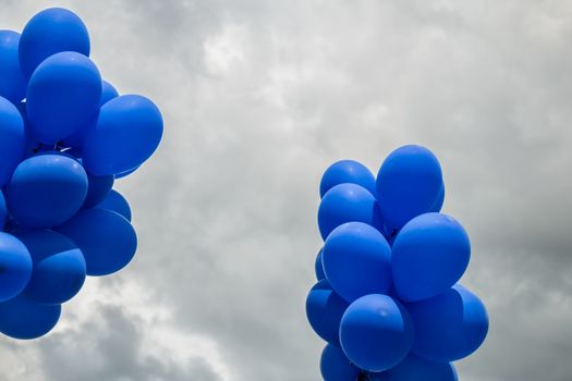 blue balloons on cloudy sky