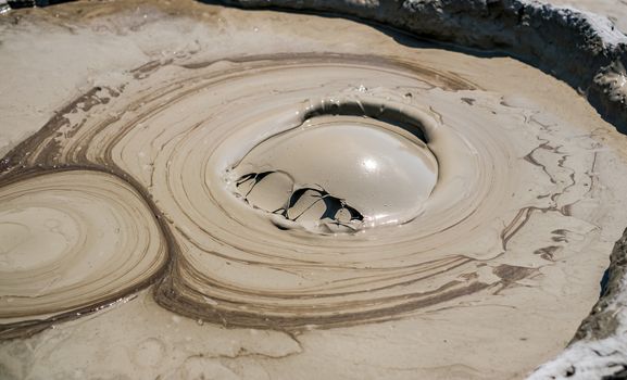 Close-up of bubbling mud in crater of mud volcano in Buzau county, Romania