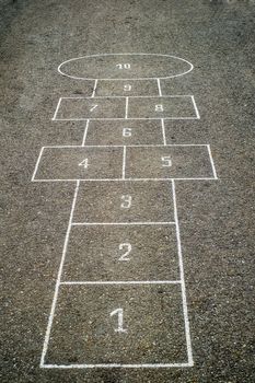 Children's Hopscotch Game on Asphalt City Sidewalk