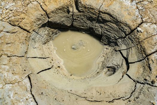 Close-up of bubbling mud in crater of mud volcano in Buzau county, Romania