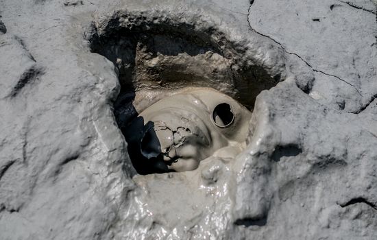 Close-up of bubbling mud in crater of mud volcano in Buzau county, Romania