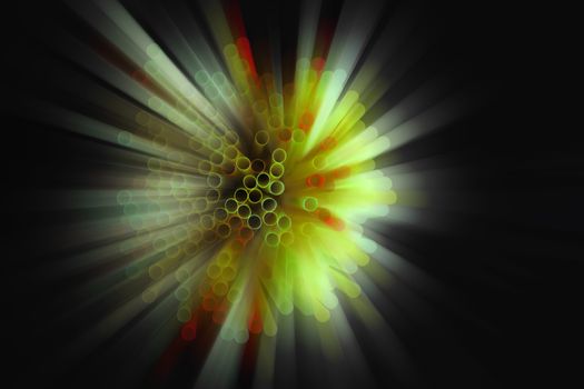 colored plastic drinking straws on black background