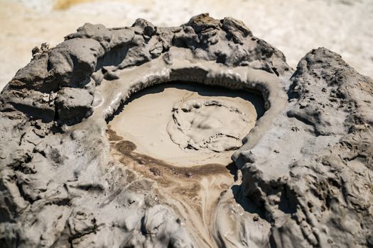 Close-up of bubbling mud in crater of mud volcano in Buzau county, Romania