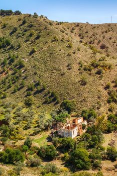 building in degradation at the foot of the hill