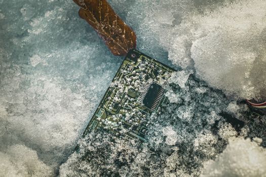 circuit board with microprocessor covered by snow