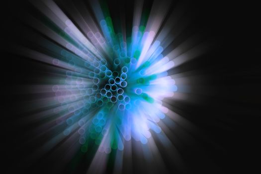 colored plastic drinking straws on black background