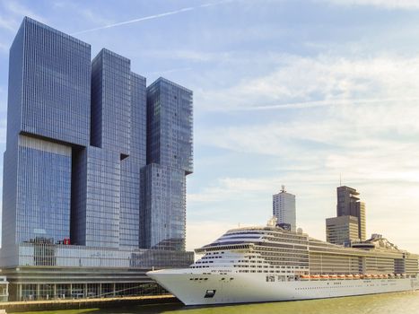 Cruise ship MSC Preziosa at Wilhelminapier with De Rotterdam business towers. Travel and toursim in Netherlands