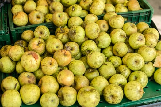green apples for sale on the market stall