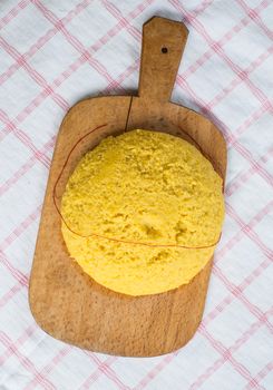 Hot steaming polenta on a old wooden board