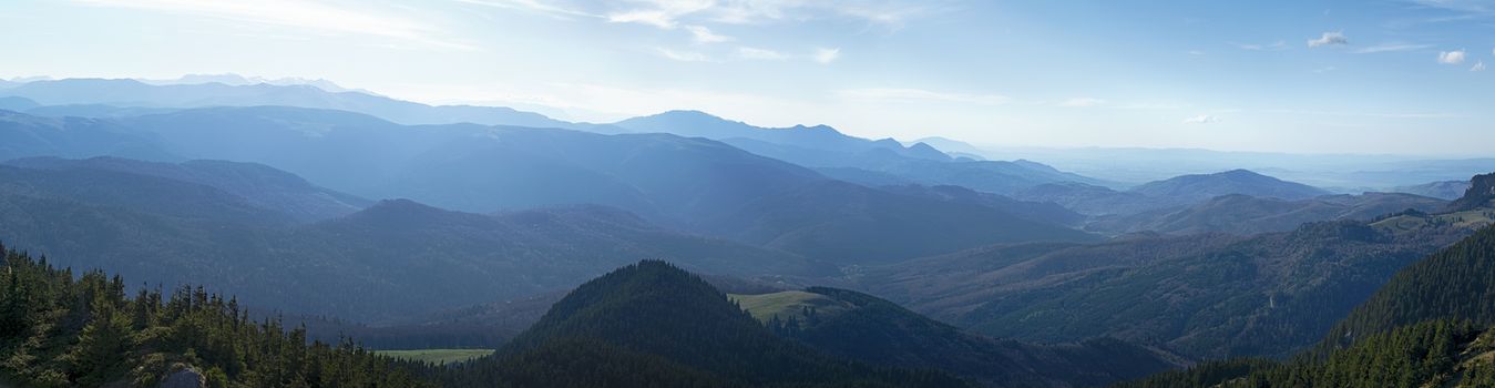 Hazy sun over the mountains peaks, Bratocea pass, Ciucas mountains, Brasov county, Romania, 1720m