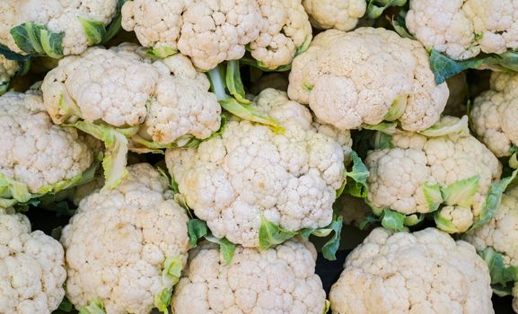 Group of cauliflowers with green leaves