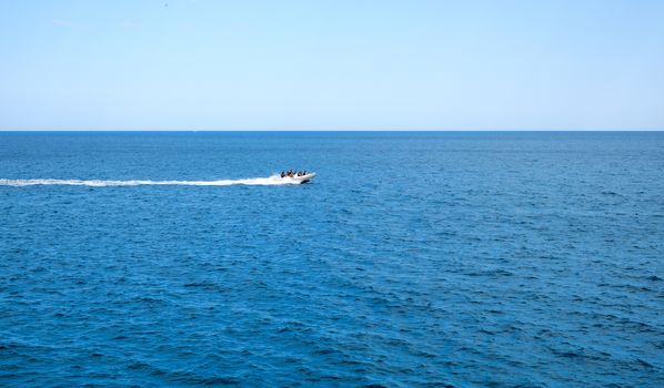 inflatable rib boat cruising in high speed in clear water sea