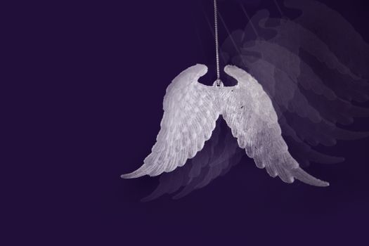 Purple Christmas background concepts with white hearts and wings with copy space