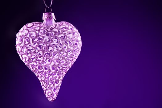 Purple Christmas background concepts with white hearts and wings with copy space