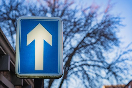 An illuminated one way road sign in england