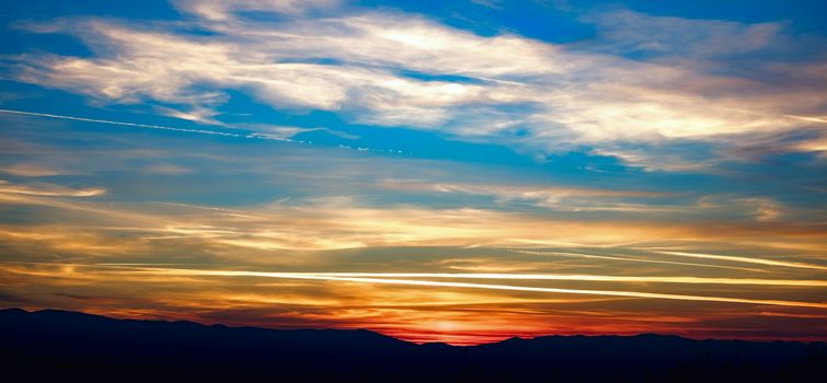 silhouettes of hills at sunset