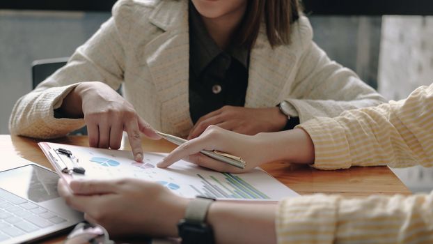 Business Corporate team brainstorming, Planning Strategy having a discussion Analysis investment researching with chart at office his desk documents and saving concept.
