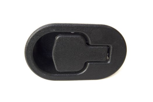 Black plastic object on a computer table used for strapping wires and cords together.