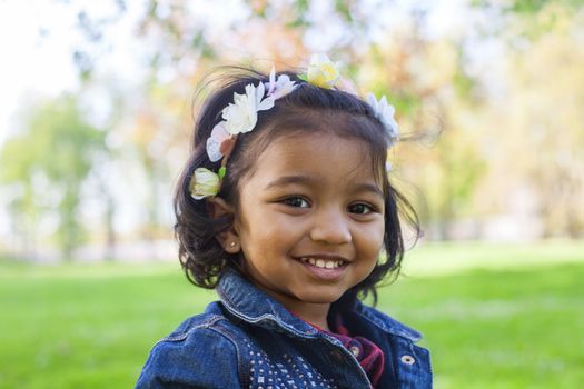 portrait of a little happy girl in spring park