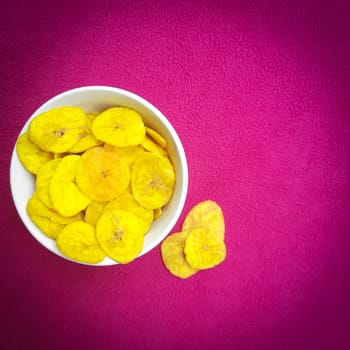 Banana chips kept in bowl beautifully placed in pink background