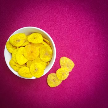 Banana chips kept in bowl beautifully placed in pink background