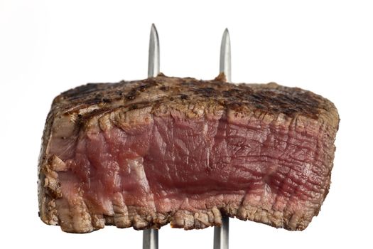 grilled steak on a meat fork