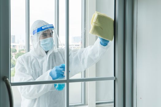 Workers wear protective clothing and wear a mask. Spraying disinfectants for cleaning inside the building. Cleaning service professionals are becoming popular After the spread of coronavirus