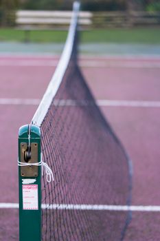 A close up of an outdoor tennis court net in the UK