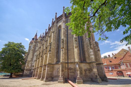 BRASOV, ROMANIA - Circa 2020: The church "Biserica Neagra" (The Black Church) situated near the square "Piata Sfatului". HDR view during a sunny day with blue sky.