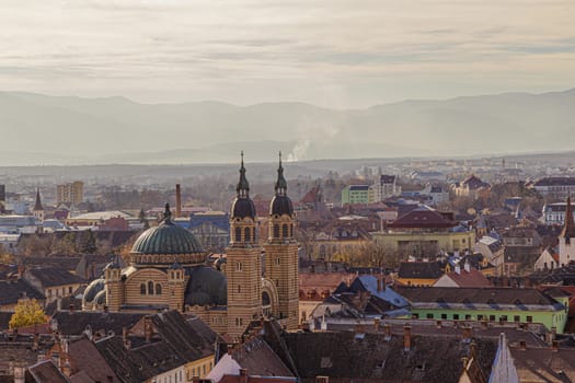 High view of old medieval town with cloudy blue sky. Beautiful tourist spot in eastern central Europe. Aerial view of famous Church in Sibiu Romania