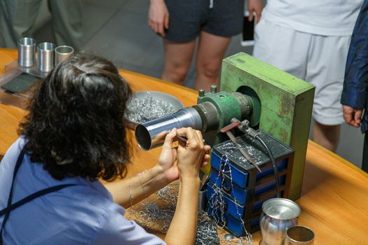 KUALA LUMPUR, MALAYSIA - CIRCA 2018: Tourists visit the production process of kitchenware,jewelry accessories from tin ore mixed with antimony and copper called Pewter. This factory is named Rayal Sal
