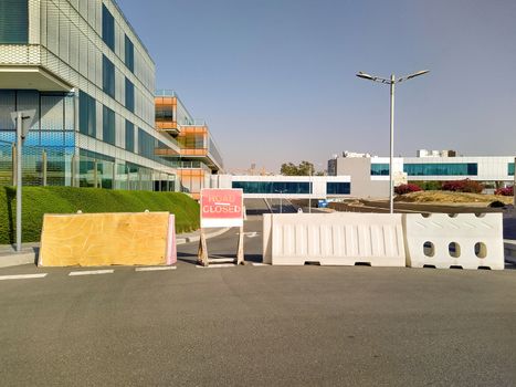 Dubai, UAE - CIRCA 2020: Road closer sign and road blockade near a hospital. Concept of road diversion.