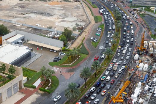 Dubai, UAE - CIRCA 2020: Big long traffic jam caused by have rains. Cars slowly crawling trough big water pods caused by storm water.