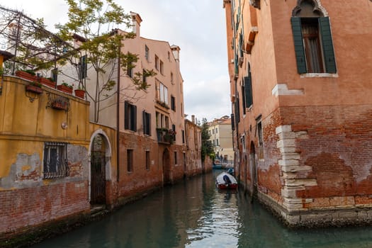 Venice, Italy - CIRCA 2020: View of an empty water canal in Venice Italy. Concept of the effects of lock down due to CoronaVirus COVID-19. Picturesque landscape.