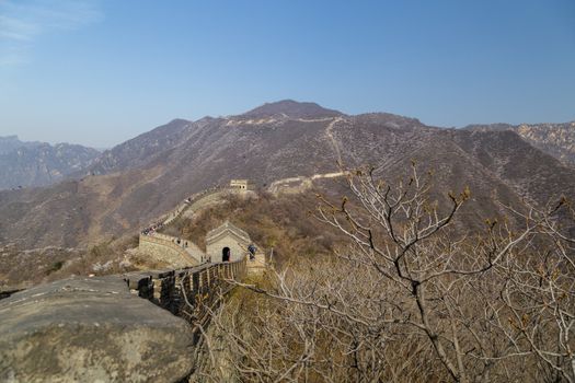 Beijing, China - CIRCA 2020: Great Wall of China in a green forest landscape at Mutianyu in Huairou District near Beijing, China. Autumn view of Grate Wall of China