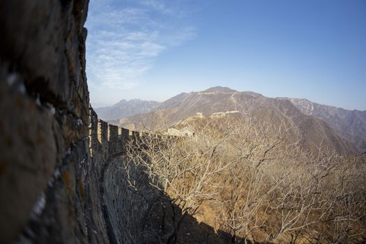 Beijing, China - CIRCA 2020: Great Wall of China in a green forest landscape at Mutianyu in Huairou District near Beijing, China. Autumn view of Grate Wall of China
