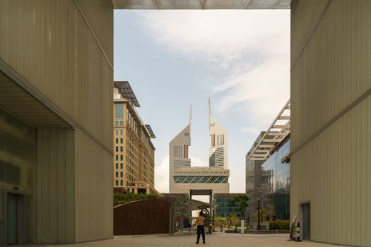 UAE, DUBAI, CIRCA 2020: Dubai Financial center district. View of The Gate and Jumeirah Emirates Towers in DIFC. Day view with cloudy sky