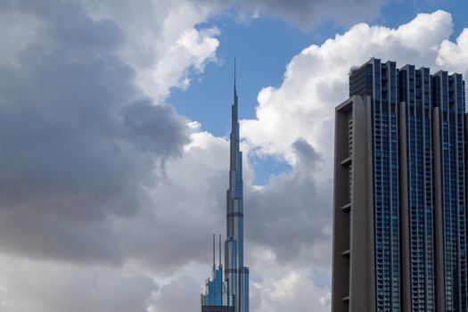 DUBAI, UAE - CIRCA 2020: Close up of the top of Burj Khalifa covered in low level clouds. Burj Khalifa is the tallest structure in the world, standing at 829.8 m (2,722 ft).