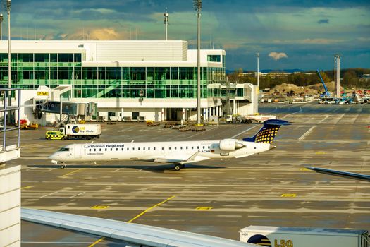 GERMANY, MUNICH - CIRCA 2020: Lufthansa Regional Airline Airplane getting ready for take off or landing at Munich airport. Travel concept