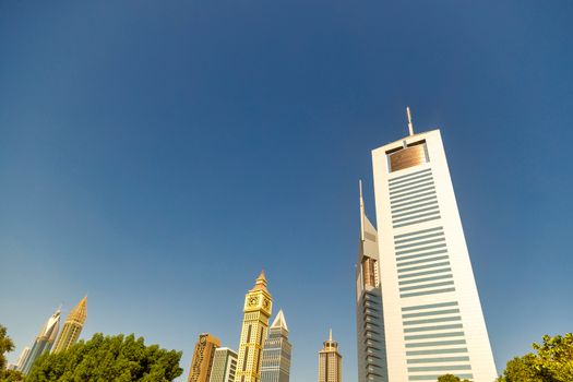 UAE, DUBAI, CIRCA 2020: Dubai Financial center district. View of The Jumeirah Emirates Towers in DIFC. Day view with clear sky