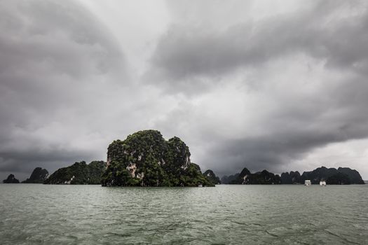 View throughout the islands of Ha Long Bay on a stormy summer's day in Ha Long Bay, Vietnam